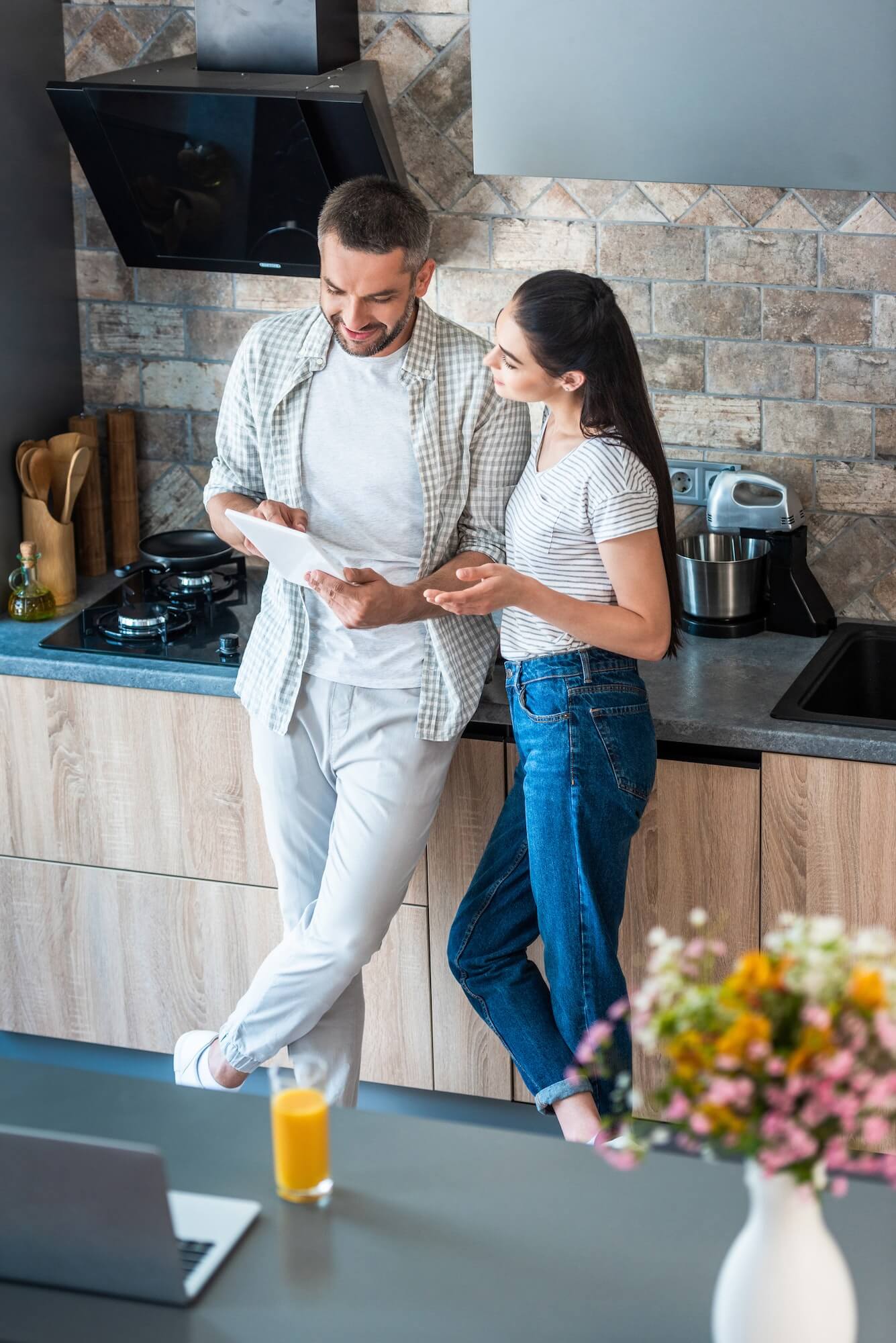 married-couple-using-digital-tablet-together-in-kitchen-smart-home-concept-1.jpg